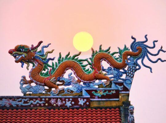 moon over a traditional chinese dragon shaped roof decoration