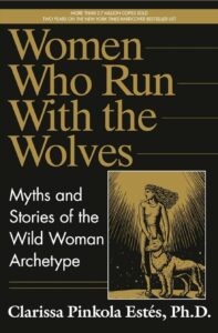 Women Who Run With the Wolves book cover by Clarissa Pinkola Estés featuring a black and gold design of a wild woman and wolf.